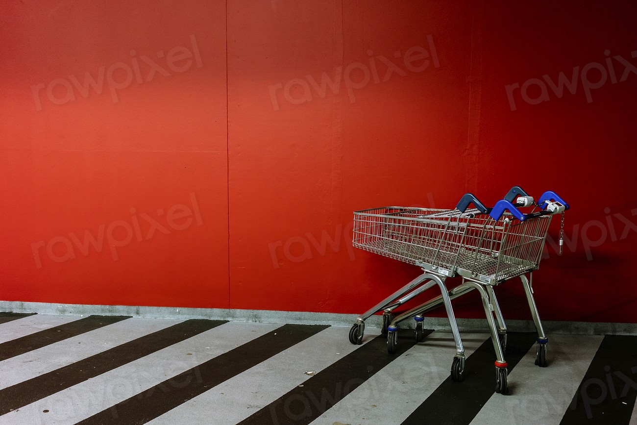 Shopping trolleys by red wall
